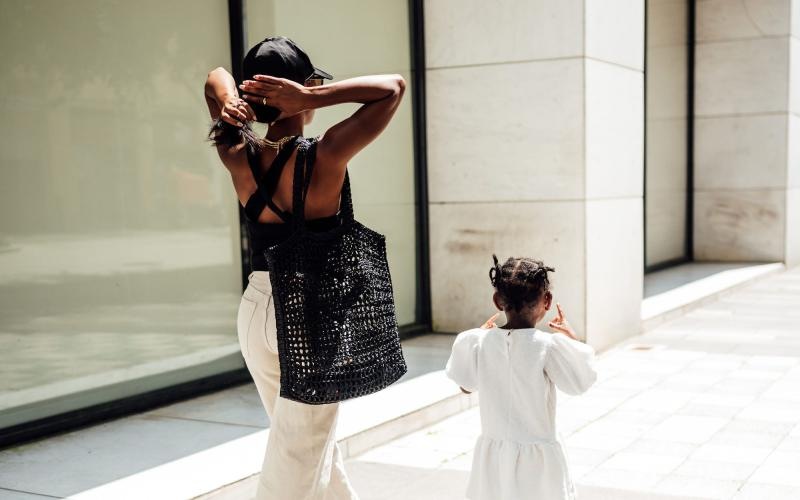 a woman walking with her child