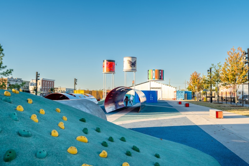 a playground with a blue climbing rock