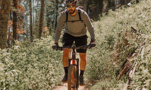 man riding a bike on a trail in the woods