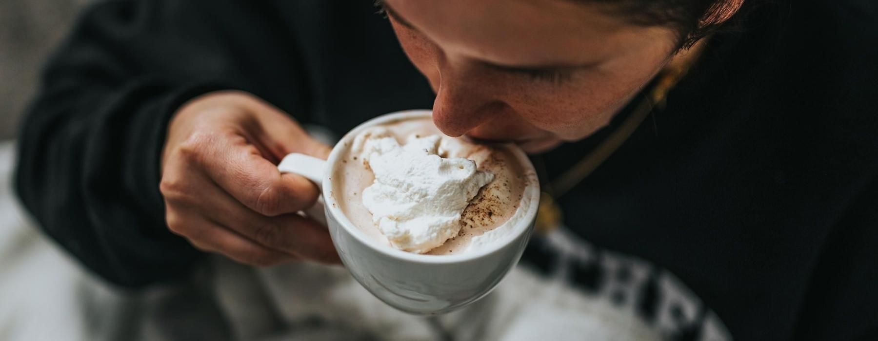 man sipping a hot beverage