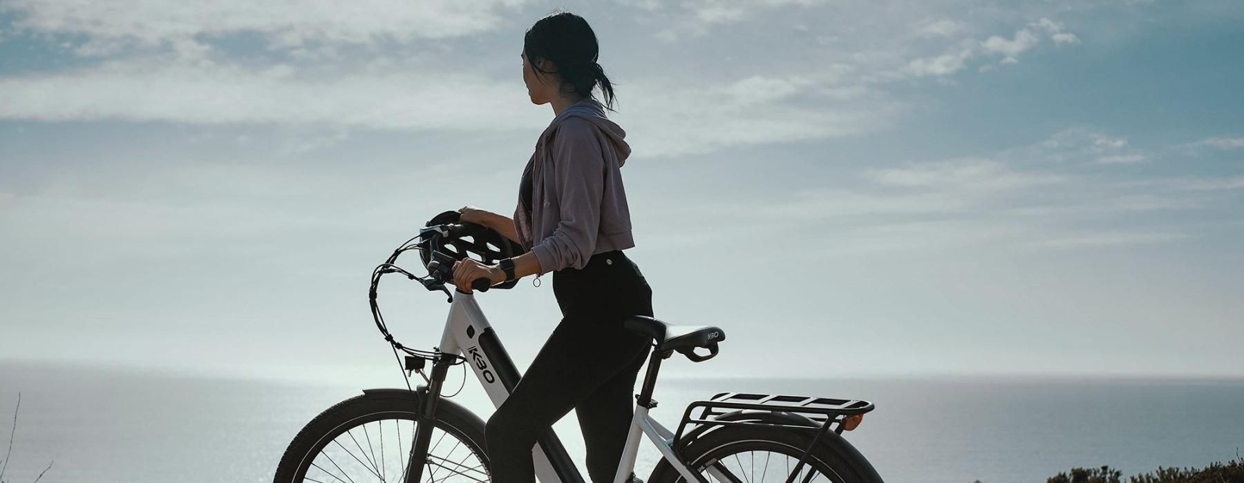 a woman standing next to a bicycle